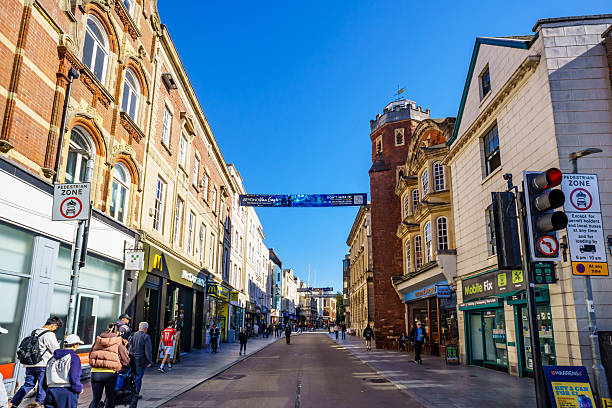Exeter, UK. 23 September 2025. Shops and shoppers on the High Street in Exeter