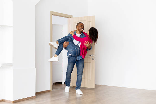 istock Happy black man carrying smiling partner in arms while entering new home 2237088598