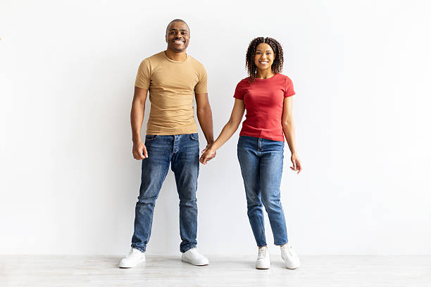 istock Smiling African American couple holding hands together while facing camera 2237088941