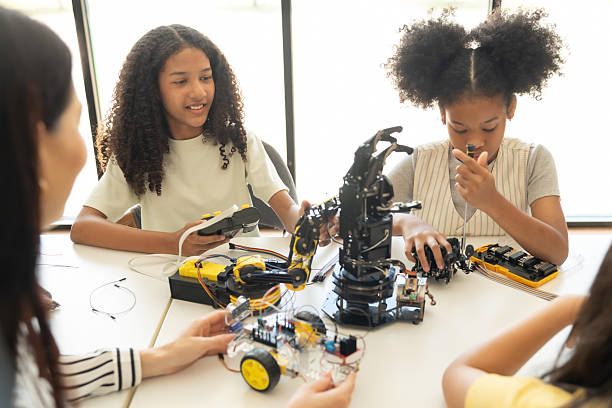 istock Focus Robotic Arm, Children Learning with Teacher in Hands-On STEM Activity.Multiracial students in robotics class with robot vehicle. 2237089800