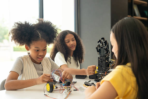 istock Focus Robotic Arm, Children Learning with Teacher in Hands-On STEM Activity.Multiracial students in robotics class with robot vehicle. 2237089845
