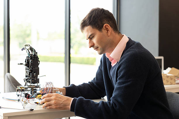 istock Focus Robotic Arm, Teacher lookng camera in Classroom. 2237089985