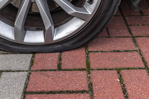 istock A flat tire on a passenger car parked in a parking lot, 2237090116