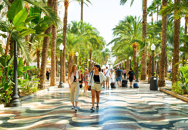 Alicante, Spain - 19 September, 2025: tourists walking on the esplanade in the city of Alicante, Spain - a coastal city on the Costa Blanca.