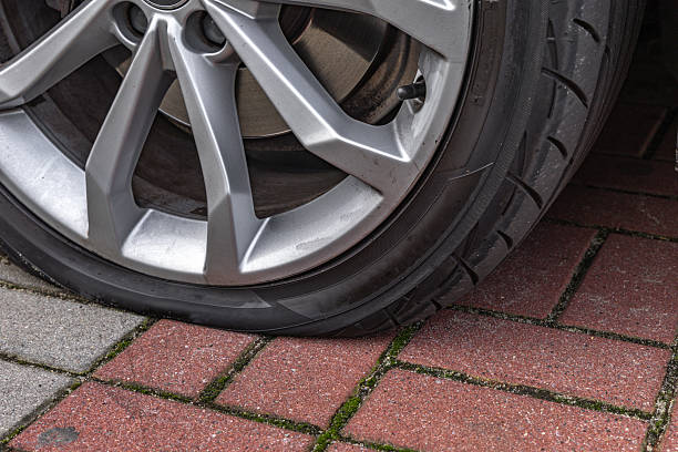 istock A flat tire on a passenger car parked in a parking lot, 2237090546
