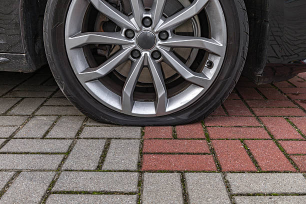 istock A flat tire on a passenger car parked in a parking lot, 2237090552