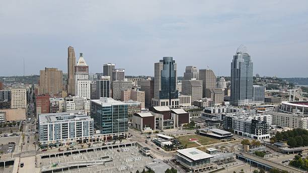 Aerial drone view of Cincinnati, Ohio, featuring the downtown skyline and cityscape under clear skies. Scenic urban landscape ideal for business, travel, and lifestyle concepts
