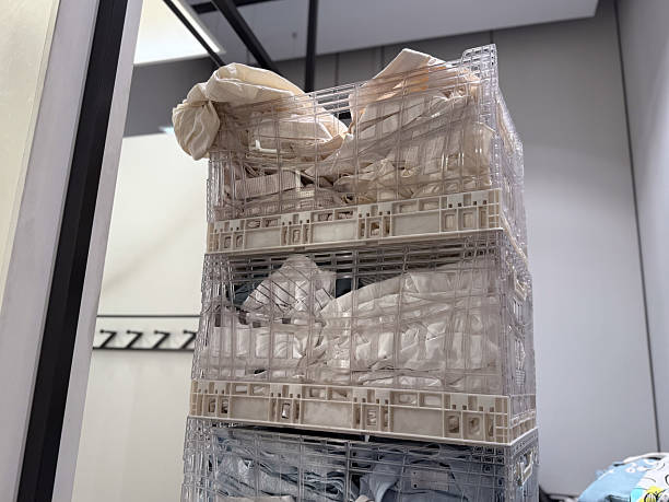 istock Stacked crates filled with folded textiles highlight the storage process in a retail environment. Supply, distribution, material organization and commercial logistics in modern fashion industry. 2237091392