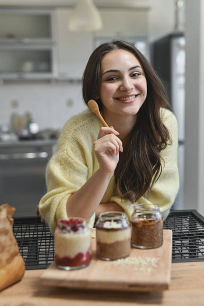 istock Joyful Woman Displaying Homemade Oats Jars While Smiling At Camera 2237091543
