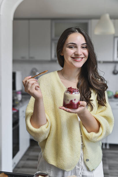 istock Happy Female Holding Nutritious Breakfast Jar And Smiling Confidently 2237091572