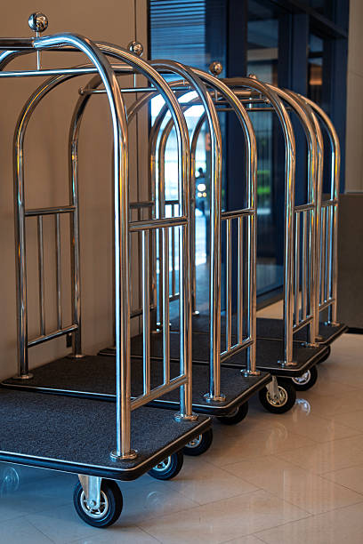 istock Hotel luggage carts lined up in lobby 2237092364