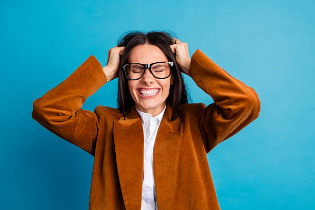 istock Successful businesswoman with vibrant elegance expressing excitement while posing against a bright blue background 2237092457