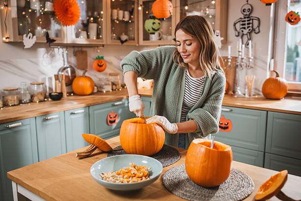 istock Woman carving pumpkin for Halloween 2237093125