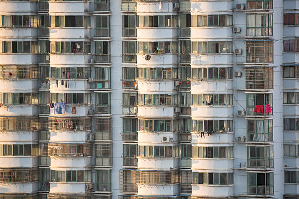 This residential high-rise presents a striking facade dominated by densely clustered balconies and windows. This repetitive, grid-like pattern creates a sense of ordered uniformity and scale. The design prioritizes functionality, maximizing light, air, and views for each unit within a compact footprint. While some may find the sheer repetition imposing, it reflects the practical demands of urban density. From a distance, the building appears as a textured, geometric honeycomb, a testament to modern architecture's response to housing large populations vertically. The countless individual windows collectively form the imposing, monolithic identity of the structure itself.