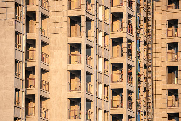 This residential high-rise presents a striking facade dominated by densely clustered balconies and windows. This repetitive, grid-like pattern creates a sense of ordered uniformity and scale. The design prioritizes functionality, maximizing light, air, and views for each unit within a compact footprint. While some may find the sheer repetition imposing, it reflects the practical demands of urban density. From a distance, the building appears as a textured, geometric honeycomb, a testament to modern architecture's response to housing large populations vertically. The countless individual windows collectively form the imposing, monolithic identity of the structure itself.