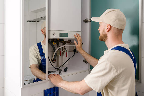 istock Repairman maintaining gas boiler in modern bathroom for efficient heating 2237094805