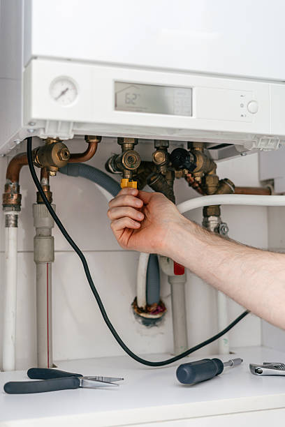 istock Repairman working on a modern gas boiler in a utility room for efficient heating 2237095338
