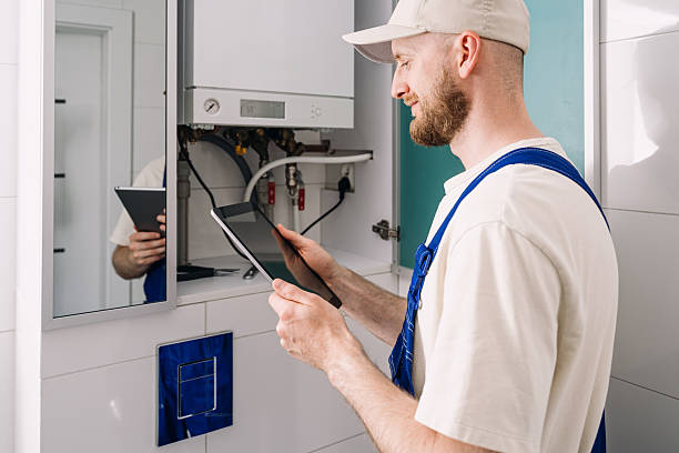 istock Repairman performs maintenance on gas boiler in modern bathroom setup 2237095385