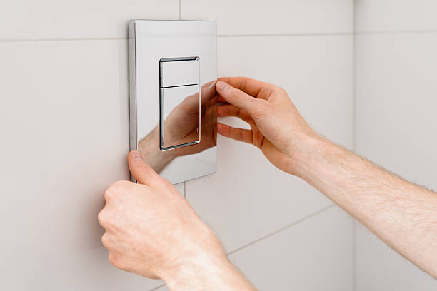 istock Repairman installs a flush button on a concealed cistern in a modern restroom 2237095404