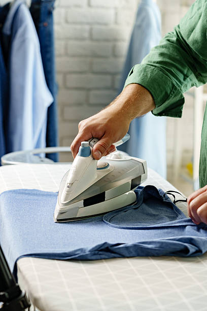 istock Ironing a blue shirt on a tabletop in a home laundry space during daylight hours 2237095420