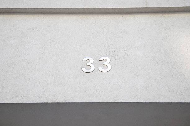 istock Number 33 on the wall of a building 2237099379