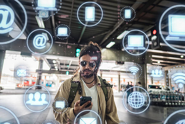 istock Mid adult man walking while using the mobile phone with futuristic digital technology interface at the airport 2237100051