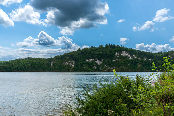 istock Forested hill above calm summer lake 2237100631