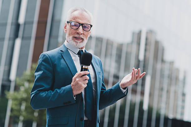 istock Confident senior businessman speaking with professionalism outdoors in urban setting wearing formal suit 2237103449