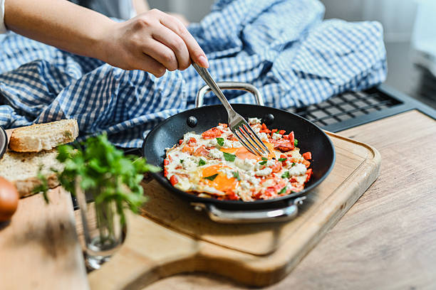 istock Female Checking Egg Yolk With Fork In Shakshouka Dish 2237105246