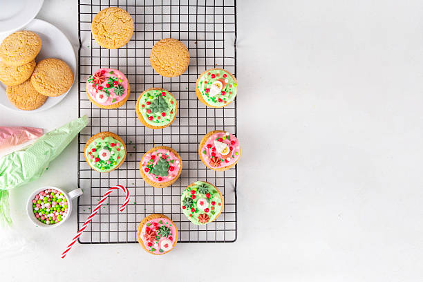 Festive Christmas decorated crumble cookies. Tasty american crumbl cookies copycat with green and red whipped cream frosting and Christmas sugar decorations on top, copy space
