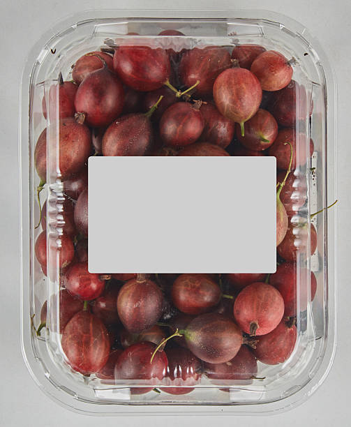 Red raspberry grapes in a clear plastic box isolated nature background with clipping path