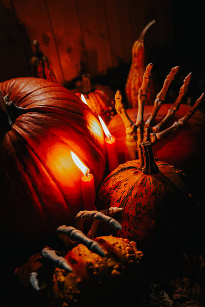 istock Halloween Pumpkins with Candles and Skeleton Hands 2237111018