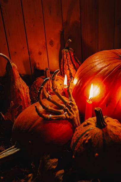 istock Pumpkins and Candles with Skeleton Hand Decoration 2237111020