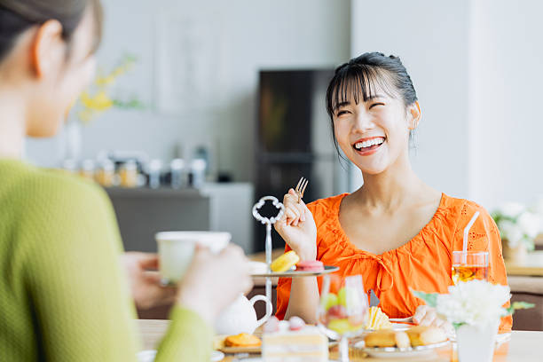 istock Young woman enjoying afternoon tea at a cafe 2237112159