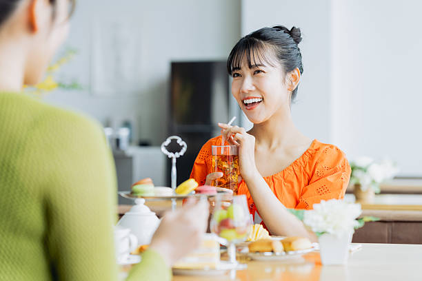istock Young woman enjoying afternoon tea at a cafe 2237112160