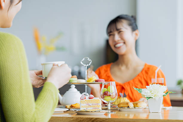 istock Young woman enjoying afternoon tea at a cafe 2237112162