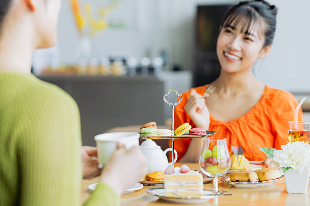 istock Young woman enjoying afternoon tea at a cafe 2237112168