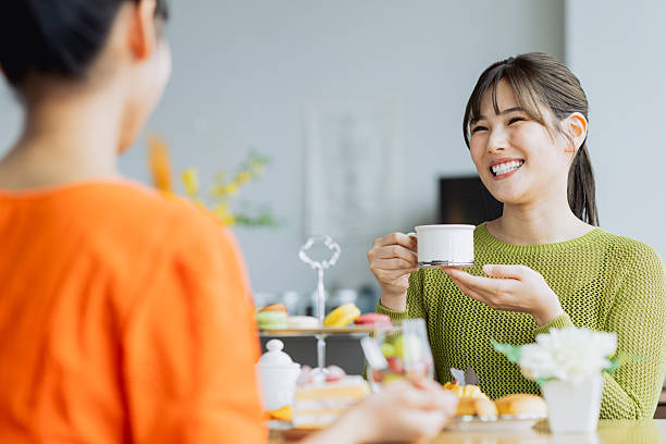 istock Young woman enjoying afternoon tea at a cafe 2237112171