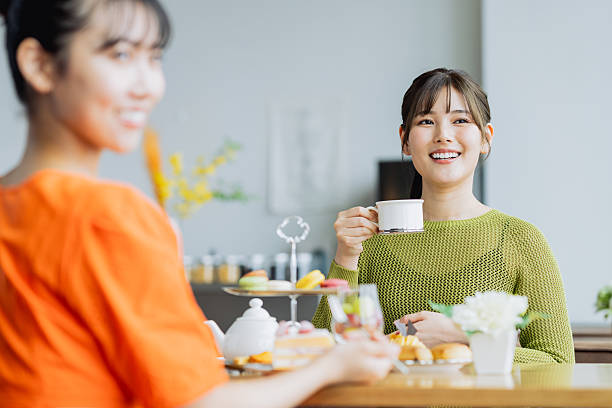 istock Young woman enjoying afternoon tea at a cafe 2237112175