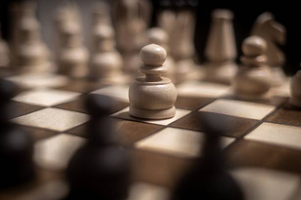 istock Close-up of a chessboard with a focus on a white pawn. 2237115291