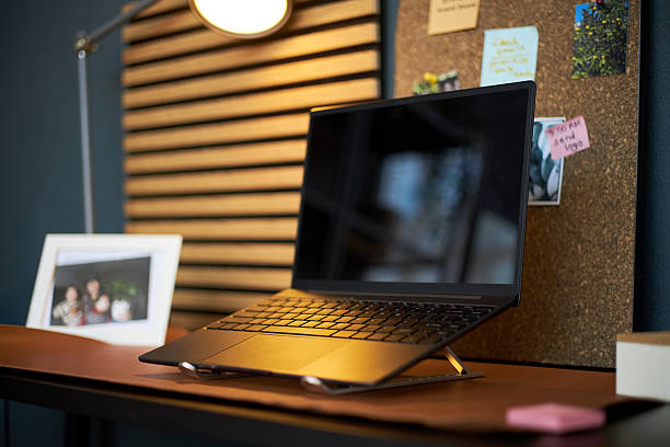 istock Modern Laptop Sitting on Desk in Home Office Workspace with Cork Board 2237115652