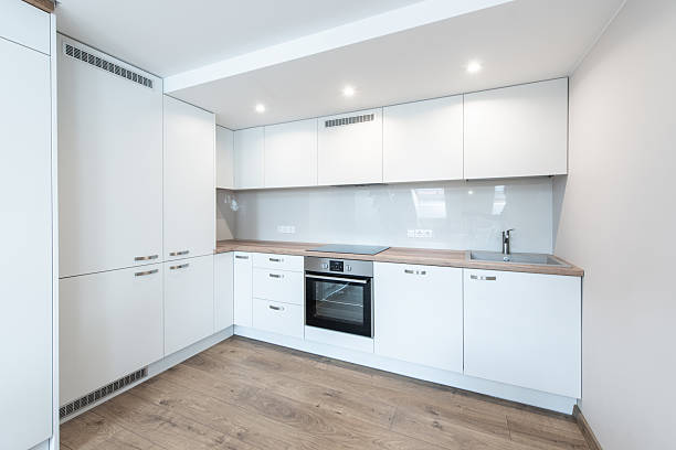 istock Modern Home Minimalist Kitchen Interior with White Cabinets and Wooden Flooring 2237117139