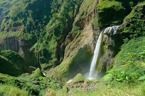 istock Scenic waterfall in lush green mountains 2237119347