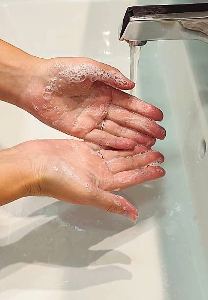 istock Woman washes hands in the bathroom 2237120204