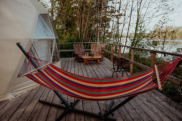 istock A colorful hammock rests on a wooden deck by a cozy tent 2237121991