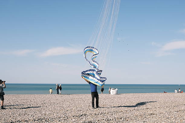 People walking and kite surfing at North Sea beach of Noordwijk aan Zee, The Netherlands.