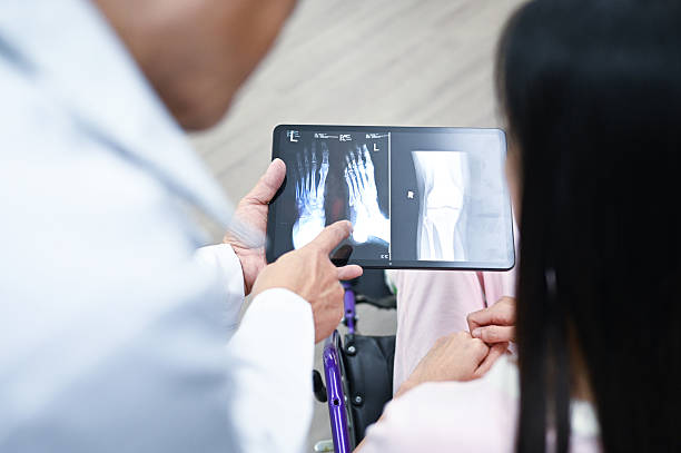 istock Professional Doctor Interpreting X-Ray for Injured Patient 2237125629