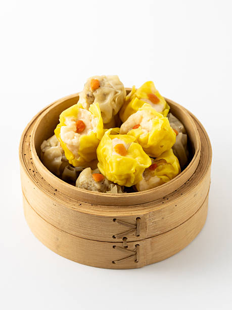 istock Delicious Steamed Dumplings in Bamboo Basket on White Background 2237126476