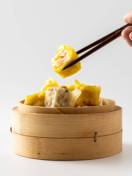 istock Delicious Fresh Dumplings Served in Bamboo Steamer with Chopsticks 2237126482