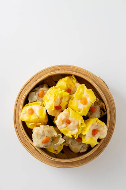 istock Brightly Colored Dumplings in Bamboo Steamer Isolated on White Background 2237126534